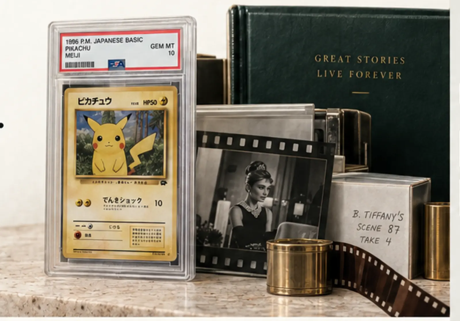 An archival still life of a graded trading card, film negative, books and preservation objects